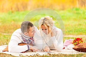 Couple on a picnic together reading novel