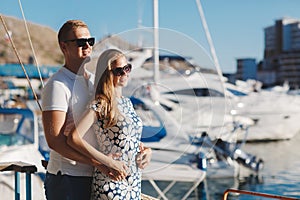 The couple on the pier near the yacht port