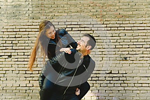 Couple in piggyback having a good time of laughter and love to celebrate their upcoming wedding