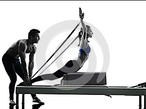 Couple pilates reformer exercises fitness isolated photo