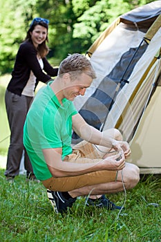 Couple pitching a tent