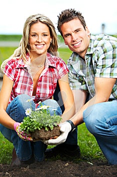 Couple planting flowers