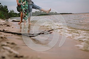 Couple play shore water splashes love clothes