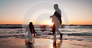 Couple, playful splash and beach in sunset, silhouette or game with love, romance or bonding on vacation. Man, woman and