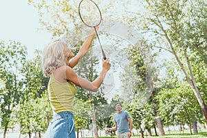 couple playing badminton outdoors