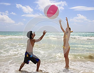 Couple playing with a ball at the beach