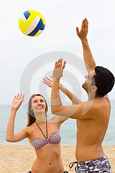 Couple playing with a ball on the beach