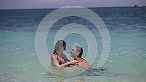 Couple playing bathing on the beach