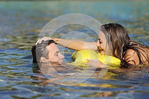 Couple playing on the beach in summer vacation