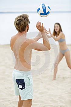 Couple playing beach volleyball