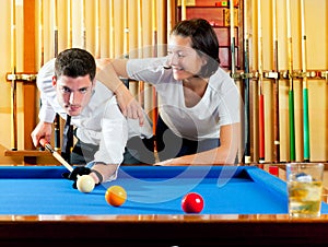 Couple playing billiard expertise teacher