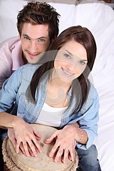 Couple playing a bongo drum
