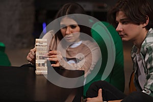 Couple playing building wooden blocks together on a date