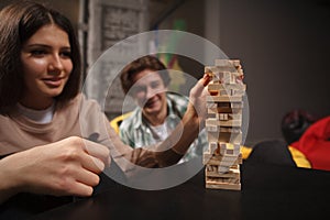 Couple playing building wooden blocks together on a date