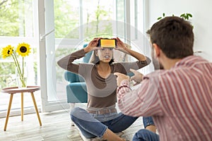 Couple playing charades wtih a smartphone app