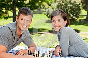 Couple playing chess in the park