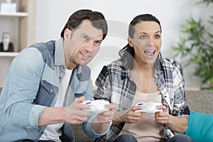 Couple playing game at home together