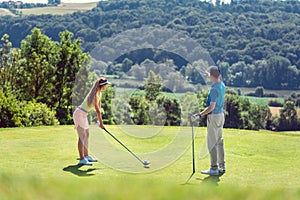 Couple playing golf on a summer day