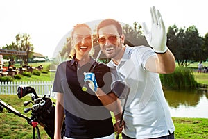 Couple playing golf on a sunny day - Image