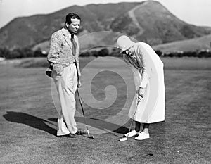 Couple playing golf together