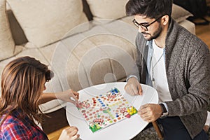 Couple playing ludo board game