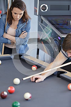 couple playing pool woman looking annoyed photo