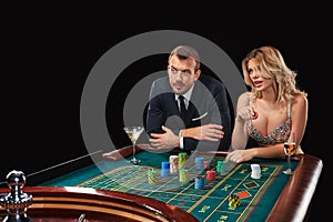 Couple playing roulette wins at the casino.