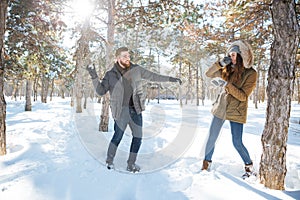 Couple playing with snow in winter park