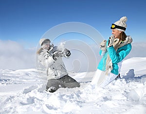 Couple playing with snowballs photo