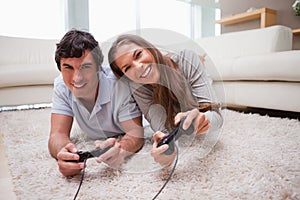 Couple playing video games on the floor