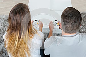 Couple playing video games at home