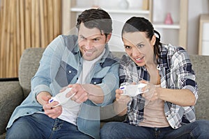couple playing video games in their apartment