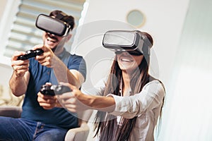 Couple playing video games virtual reality glasses. Couple having fun with new trends technology