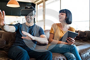 Couple playing video games with VR glasses.