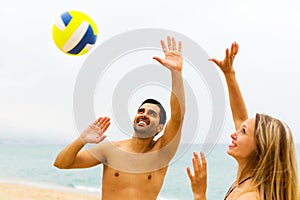Couple playing volleyball