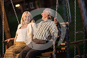 Couple on porch swing, evening.