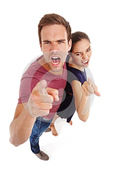 Couple, portrait and angry pointing in studio at high angle or partnership disagreement, white background or fighting