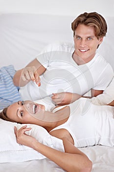 Couple, portrait and eating fruit in bed for romantic morning breakfast, honeymoon or relationship care. Man, woman and