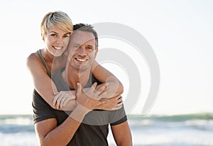 Couple, portrait and happy on beach with hug for bonding, honeymoon date and weekend holiday. Face, man and woman with