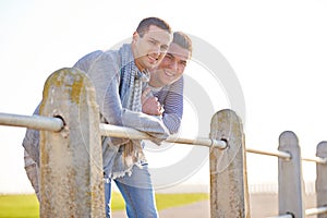 Couple, portrait and happy gay male people, smile and marriage in nature at park. LGBT, love and support or trust from
