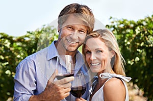 Couple, portrait and happy for wine tasting in vineyard for anniversary date, bonding or relationship. Nature, man and