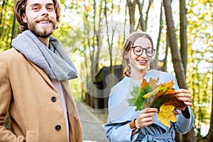 Couple portrait with leaves in the forest