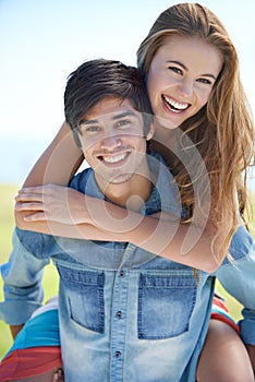 Couple, portrait and piggyback for fun in nature, love and care in relationship on outdoor date. Happy people, embrace