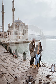 couple portrait smiling while visiting ortakoy mosque