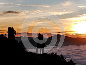 Couple pose for photo at sunrise, Kelimutu volcano, Flores, Indonesia