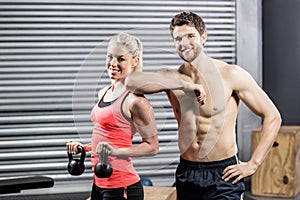 Couple posing with dumbbells