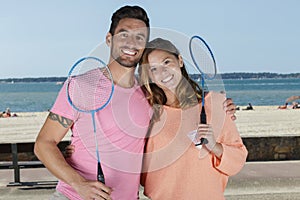 Couple posing after playing badminton outdoors