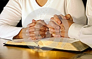 Couple Praying with Holy Bible