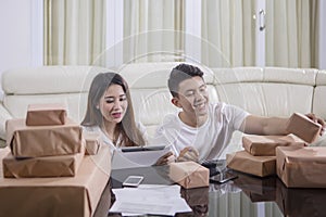 Couple preparing boxes for deliver to customer
