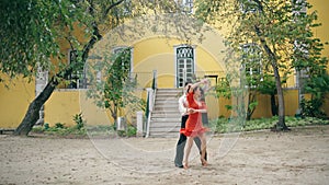 Couple professionals performing latino dance in city park. Artists dancing salsa